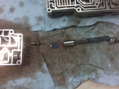1994 Ford F-150 - Disassembled transmission valve body and internal parts laid out on a shop towel.