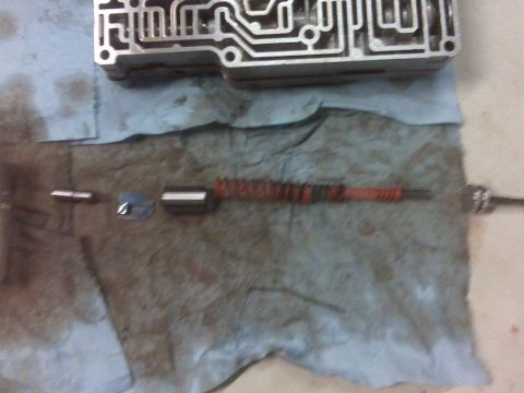 1994 Ford F-150 - Disassembled transmission valve body and associated components laid out on a shop towel.