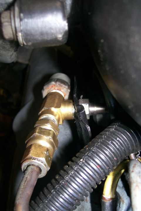 1992 Ford C-350 (Centurion Conversions) - Engine compartment detail showing a brass fitting and associated plumbing.