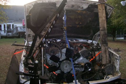 1992 Ford C-350 (Centurion Conversions) - Engine bay of a white truck with the engine removed and an engine hoist in place.