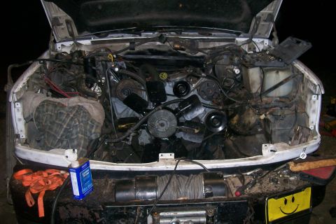 1992 Ford C-350 (Centurion Conversions) - Engine bay of a truck, showing various components and some tools nearby.