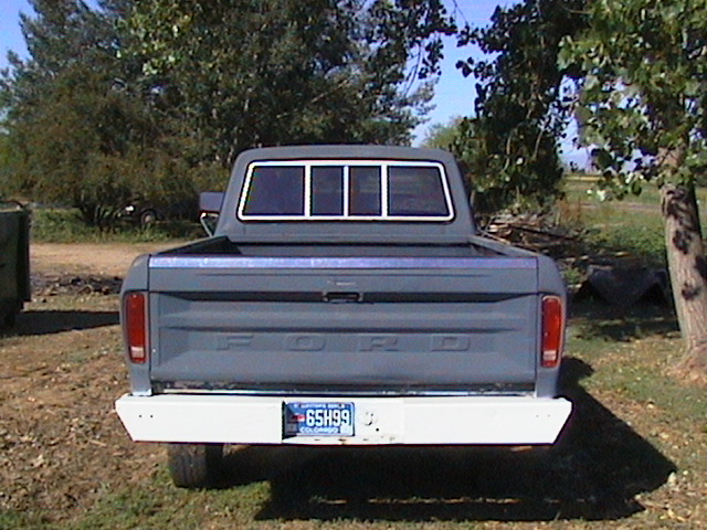 Rear view of a gray 1979 Ford F-250 pickup truck with a white bumper