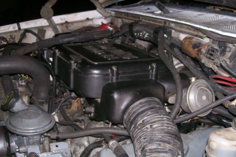 1992 Ford C-350 (Centurion Conversions) - Close-up view of an engine bay, showing various components and hoses.