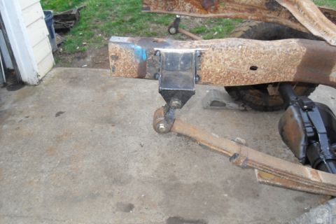 1997 Ford Ranger - A close-up view of a heavily rusted truck frame with suspension parts, showing signs of wear and tear.