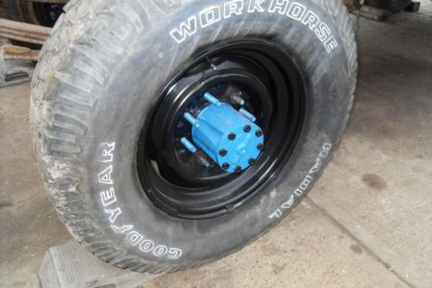 1997 Ford Ranger - Close-up of a tire and wheel assembly a bright blue hub and a Goodyear Workhorse radial tire.