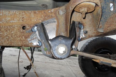 1997 Ford Ranger - This photo shows a section of a heavily rusted truck frame with recent welding repairs on the suspension mounting bracket.