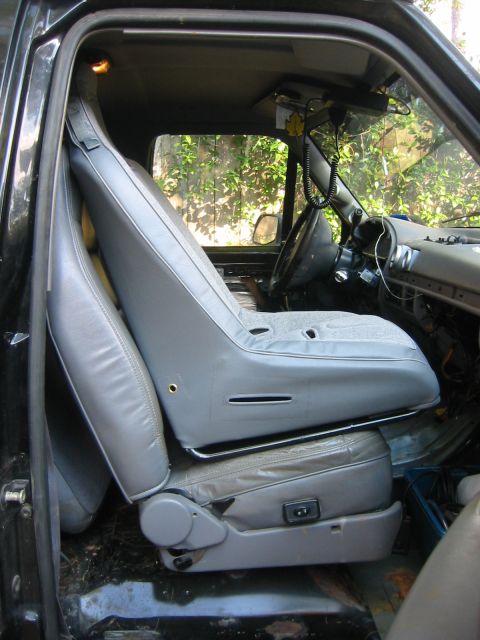 1995 Ford Bronco - The interior of a vehicle is shown, focusing on the seats and dashboard area with a CB radio installed.