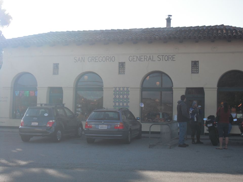 Two cars and a motorcycle parked outside San Gregorio General Store
