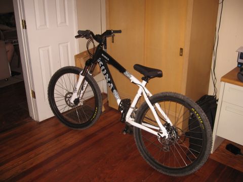 1992 Ford Ranger - A mountain bike is shown indoors, leaning against a wall near a door and cabinet.