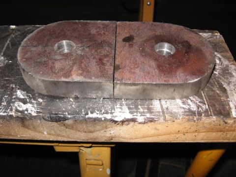 1995 Ford F-150 - Two metal components with threaded holes are shown, likely a vehicle part.