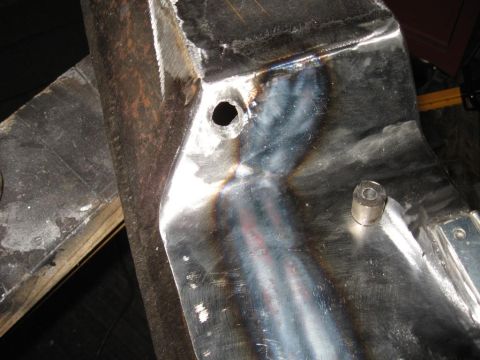1995 Ford F-150 - This image shows a close-up of a metal bumper part, likely from a truck or SUV, with visible welding marks and a bolt attachment.
