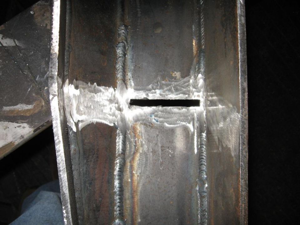 Close-up of a metal frame with visible welds and a rectangular cutout
