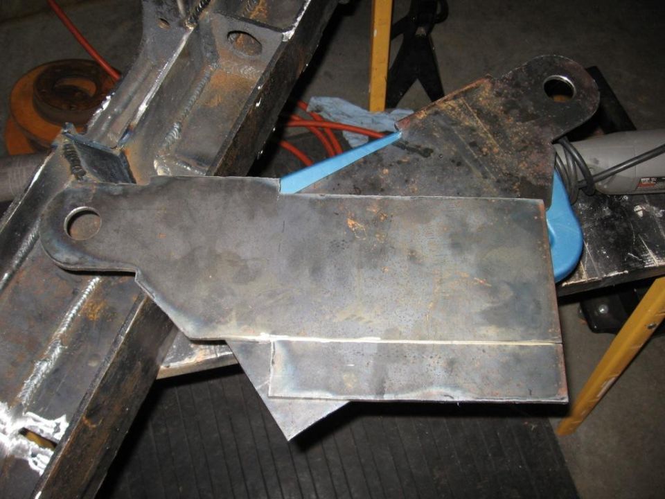 Metal bracket welded to vehicle frame, with blue clamp