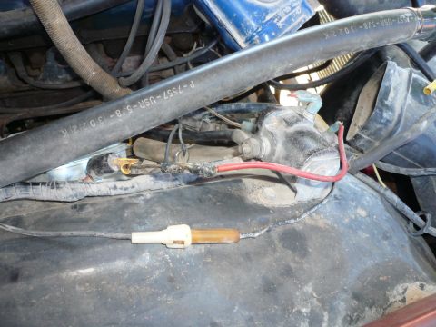 1975 Ford Ranchero - Close-up view of engine bay wiring and hoses, including a hose with a visible part number.