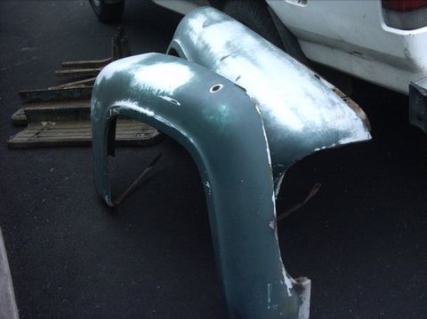 1954 Ford F-100 - These are parts of a truck, possibly fenders, that are in need of repair or have undergone bodywork.