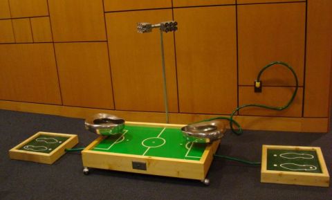 1990 Ford Bronco - A tabletop soccer game is set up on a carpeted floor in front of a wood-paneled wall.