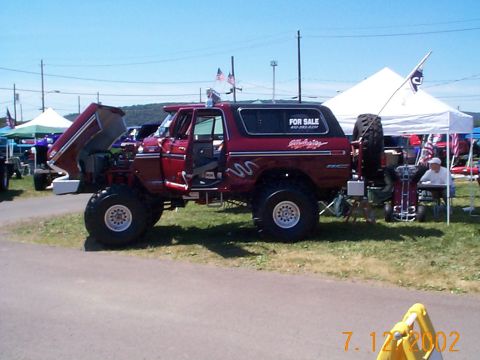 1978 Ford Bronco - A red 1978 Ford Bronco is displayed with its hood open at an outdoor event.