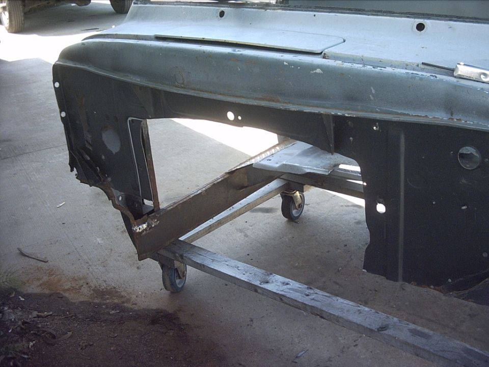 5-30-09:  Then I trimmed the rear floor a little. and cleaned up the left over welds from the old transmission tunnel. After that I spent a lot of time ( 2 hours ) measuring, test fitting, more measuring and finally marked out the firewall so I could cut it out to fit the 87 transmission tunnel. Then I pulled the transmission tunnel back out and cut out the firewall with my jigsaw.