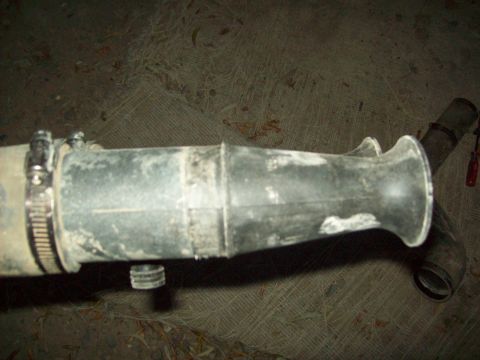 1985 Ford Bronco - This is a rubber air intake hose with metal clamps, likely a vehicle part.