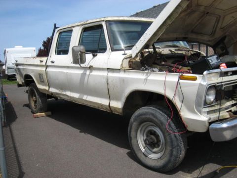 1976 Ford F-250 - This 1976 Ford F-250 crew cab pickup truck is shown with its hood open, revealing the engine compartment.