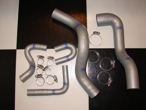 1992 Ford Taurus - Radiator hoses and clamps are laid out on a black and white checkered surface.