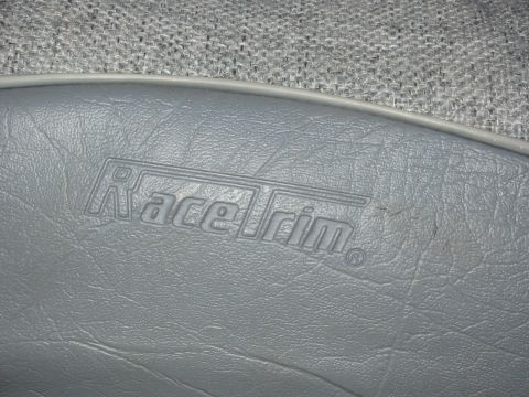 1995 Ford Bronco - Close-up of gray seat upholstery showing the embossed 'Race Trim' logo.