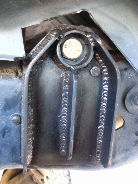1989 Ford Bronco - Close-up view of a welded bracket and bolt, likely part of a vehicle's suspension or frame.