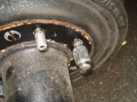 1967 Ford F-250 - Close-up of a vehicle's wheel hub assembly, highlighting the lug studs and nut.