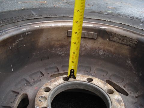 1967 Ford F-250 - Measuring a wheel with a tape measure, likely for tire or rim size.