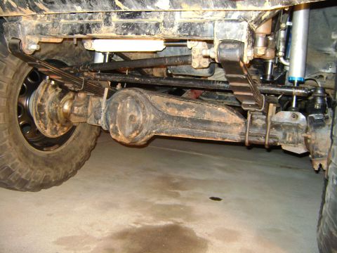 1993 Toyota 4Runner - Close-up view of the rear suspension and axle of a modified off-road vehicle.