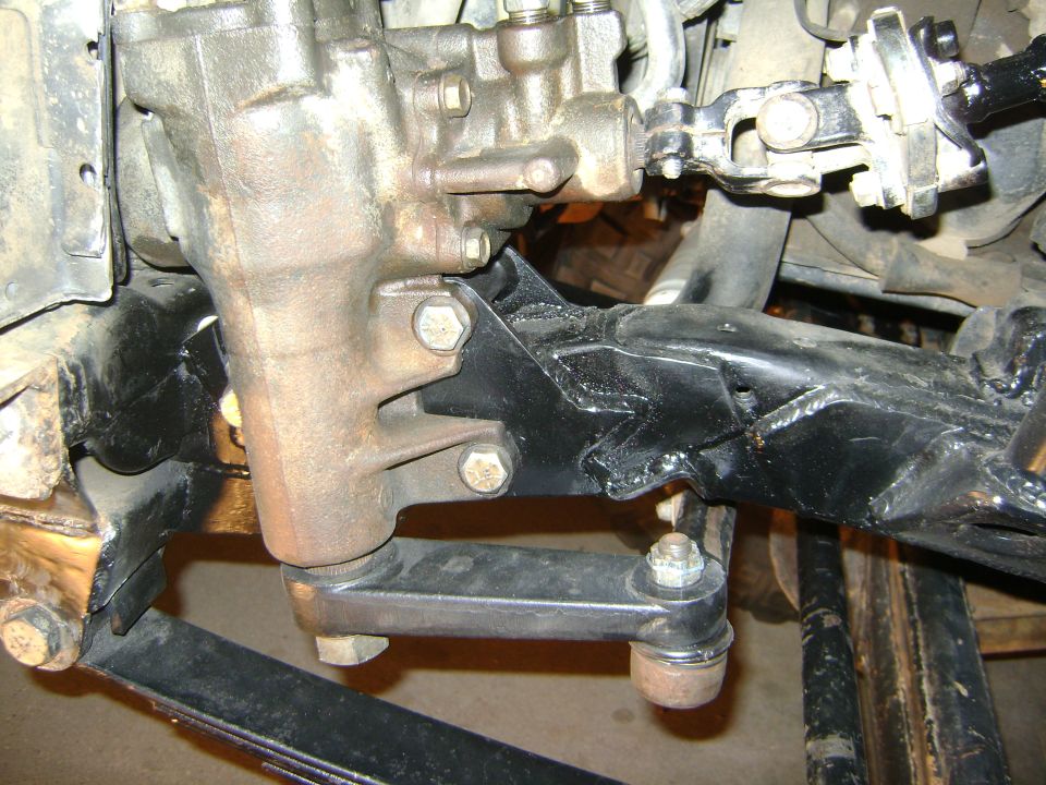 Steering gearbox and tie rod ends on a black metal bracket