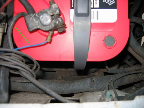 1992 Ford Bronco - A close-up view of a car battery and its associated wiring.