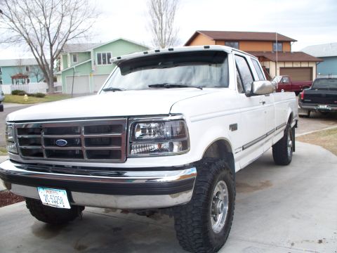1992 Ford F-250 - White 1992 Ford F-250 pickup truck with chrome grille and bumper, parked outside.