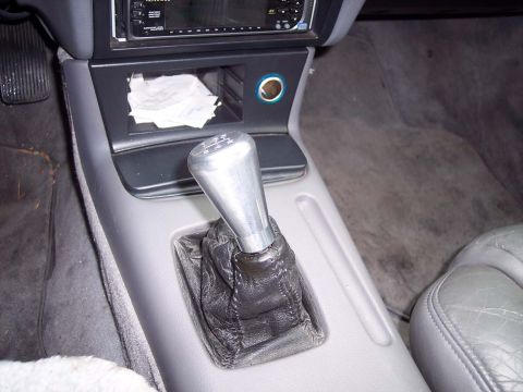 1992 Ford Taurus - Interior view of a car's center console and gear shifter, with a visible aftermarket stereo and a website logo.