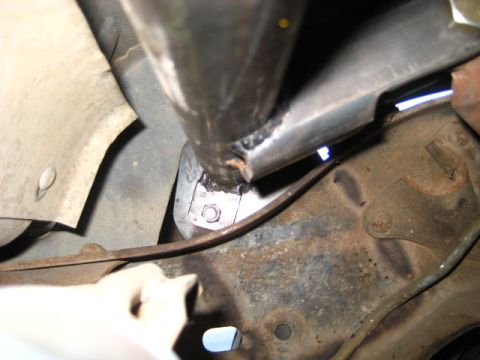 1989 Ford Bronco - Detail of a frame modification showing a welded metal bracket secured with a bolt.