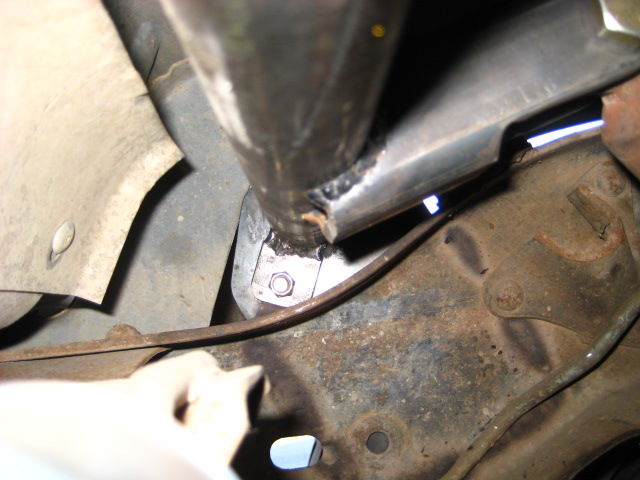 Close-up of frame modification with welded metal bracket and bolt