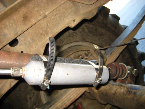 1989 Ford Bronco - Aftermarket fuel filter installed on vehicle frame, near the rear tire.