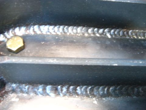 1989 Ford Bronco - Detail of welded metal components and a bolt, with a Supermotors watermark visible.