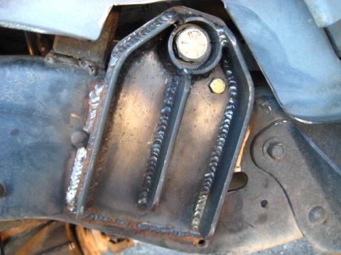 1989 Ford Bronco - Close-up view of a custom welded bracket attached to a vehicle's frame, a prominent bolt.