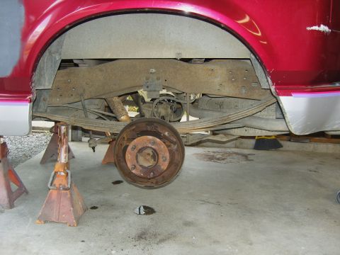 2007 Ford Mustang - Rear axle and suspension components of a vehicle undergoing maintenance.