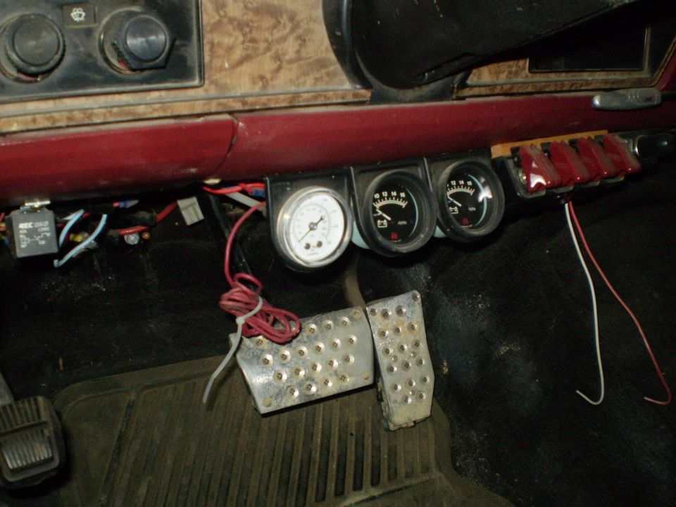 Interior dashboard with three gauges and aftermarket pedals