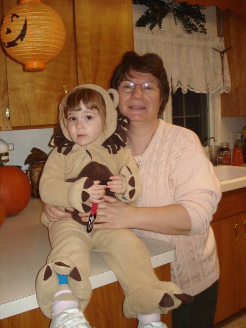 2000 Ford Crown Victoria - A woman holds a child dressed as a lion in a kitchen decorated for Halloween.