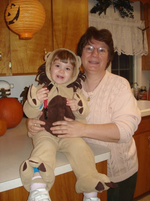 2000 Ford Crown Victoria - A woman holds a child dressed as a lion, with Halloween decorations in the background.