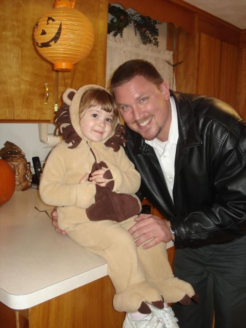2000 Ford Crown Victoria - A father and child dressed in Halloween costumes pose for a picture in a kitchen.