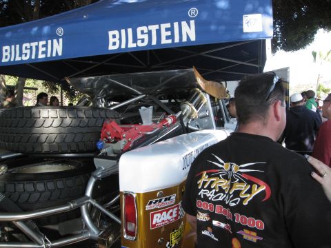 1986 Ford Bronco - A custom off-road race truck is prepared under a Bilstein branded tent.