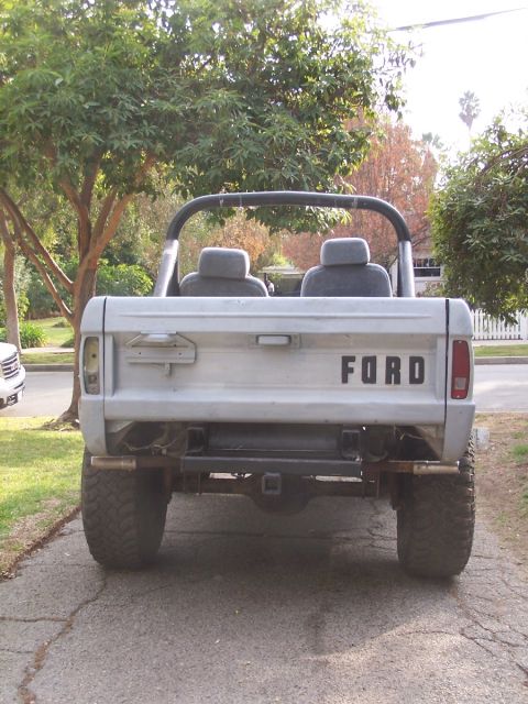 1973 Ford Bronco - This 1973 Ford Bronco is shown from the rear, its iconic tailgate with 'FORD' lettering and a roll bar.