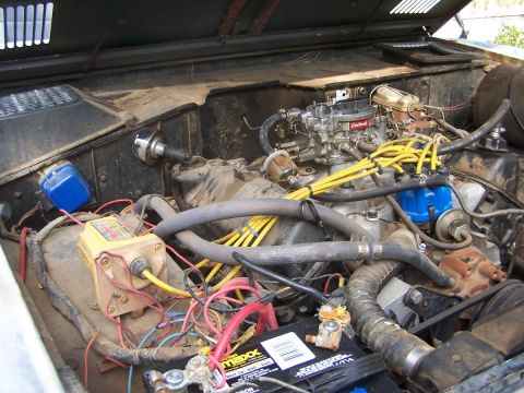 1973 Ford Bronco - Close-up of an engine bay with various components visible, including a carburetor and wiring.