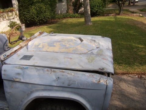 1973 Ford Bronco - This vehicle appears to be undergoing restoration, with primer and visible bodywork on the hood and fender.