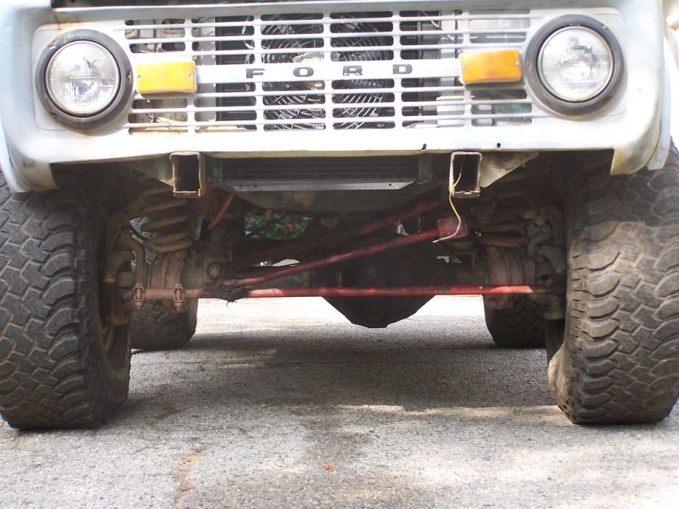 1973 Ford Bronco front grille with 'FORD' text, headlights, and off-road tires
