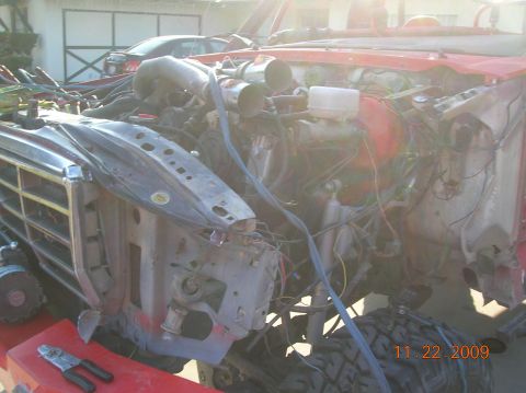 1985 Ford Bronco - The engine bay of a 1985 Ford Bronco is shown during a rebuild, with many components exposed.
